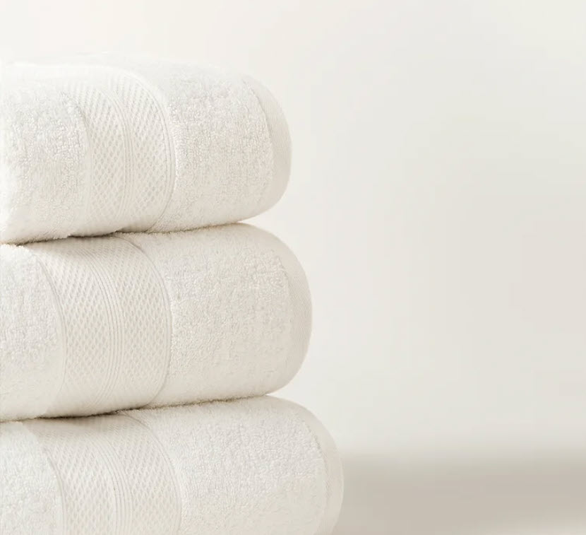 A stack of white towels on top of each other.