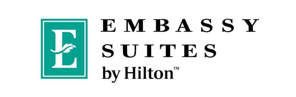 A black and white logo of the embassuite by hilton.